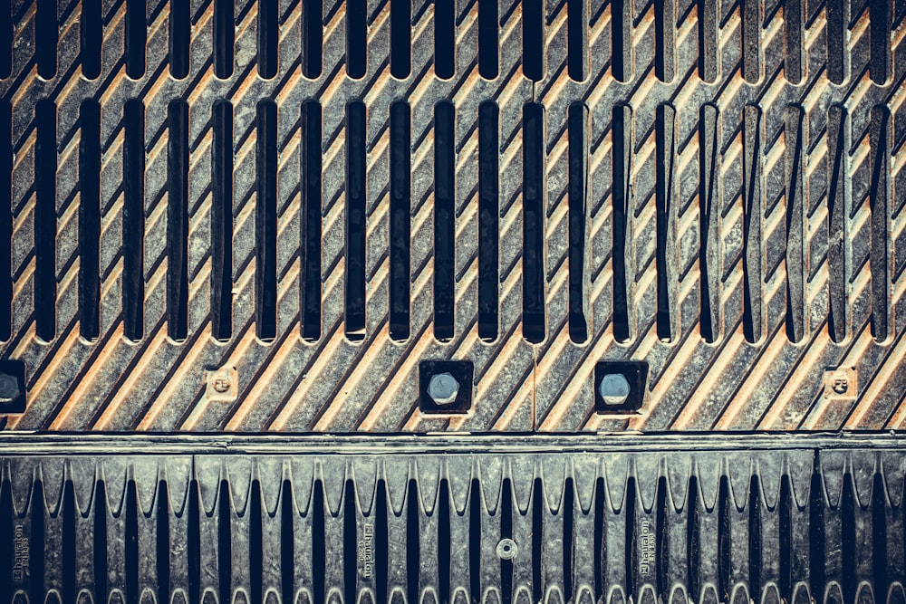 a close up of a metal grate with holes in it