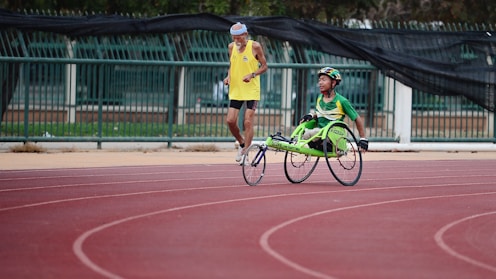 man using green wheelchair for walking
