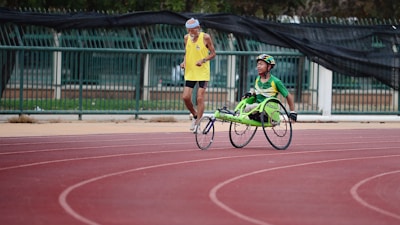 man using green wheelchair for walking