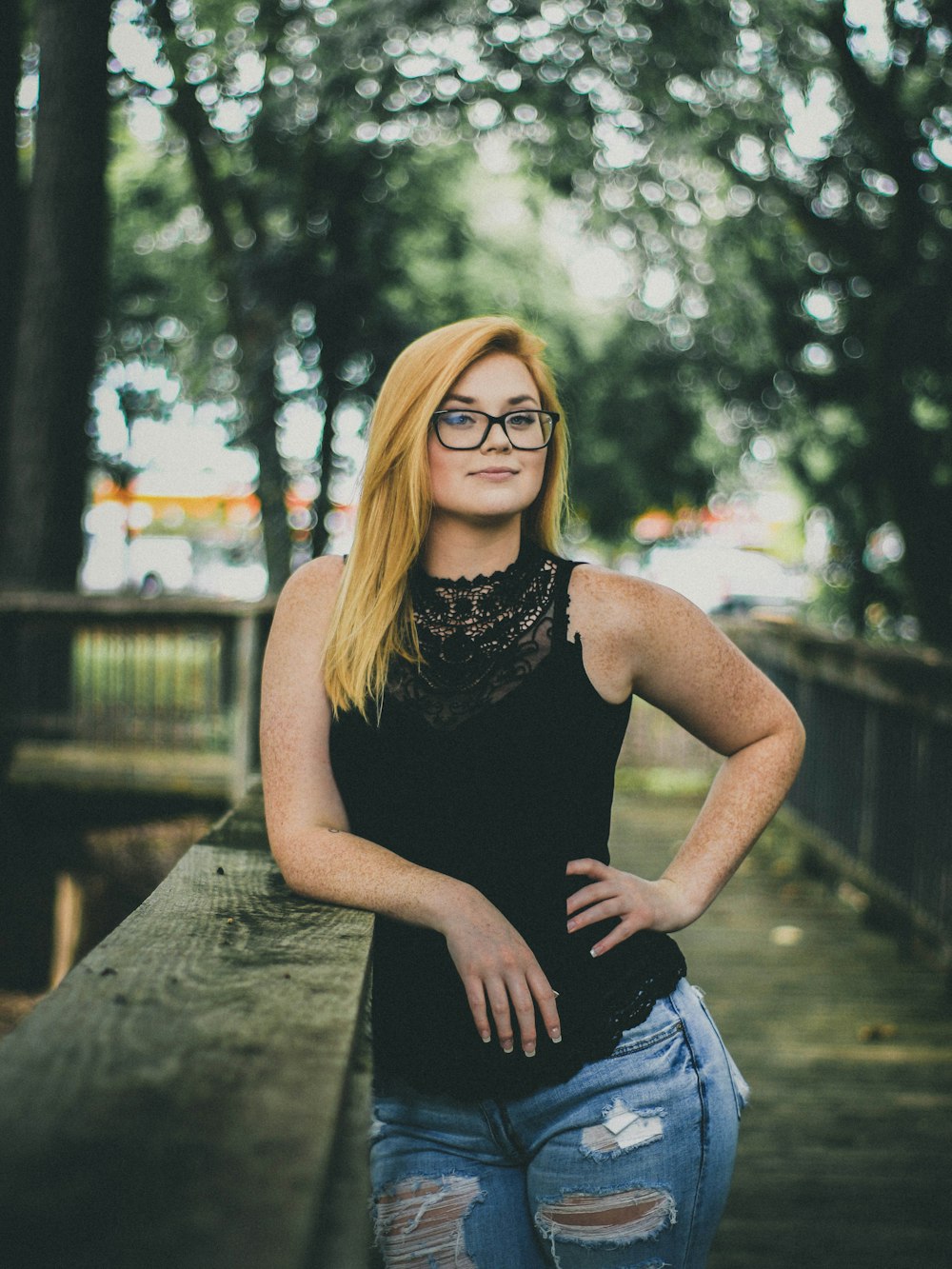 woman's arm leaning on bridge holding her waist