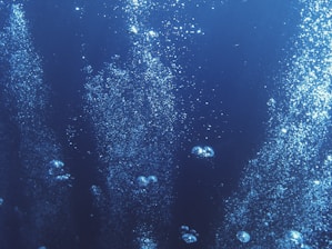 Close-up of oxygen bubbles inside the therapy capsule, glowing softly.