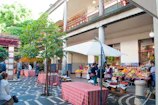 Colorful stalls filled with homegrown fruits and plants under a sunny sky