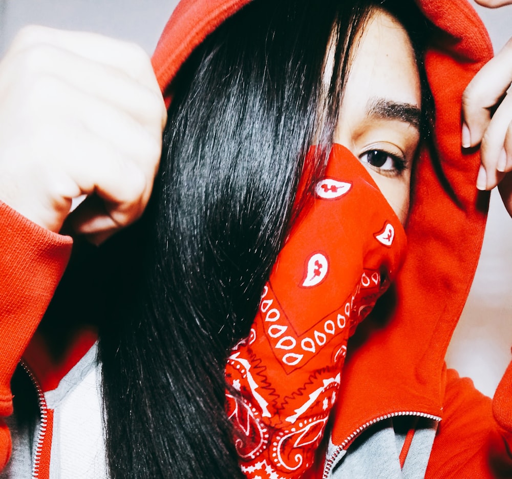 woman wearing red and white paisley scarf taking close-up selfie