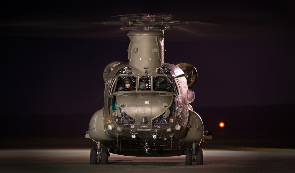 gray helicopter on land at night time