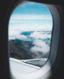 aerial photo of mountains and clouds under blue sky