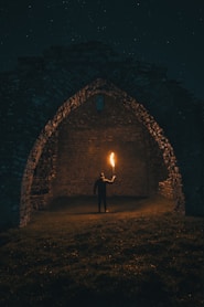 person holding torch in building interior