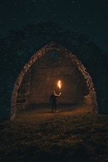 person holding torch in building interior