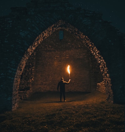 person holding torch in building interior