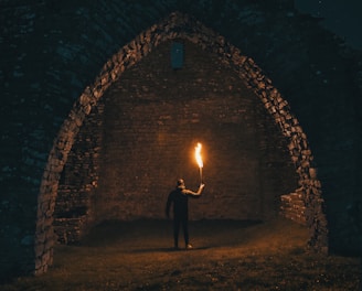 person holding torch in building interior