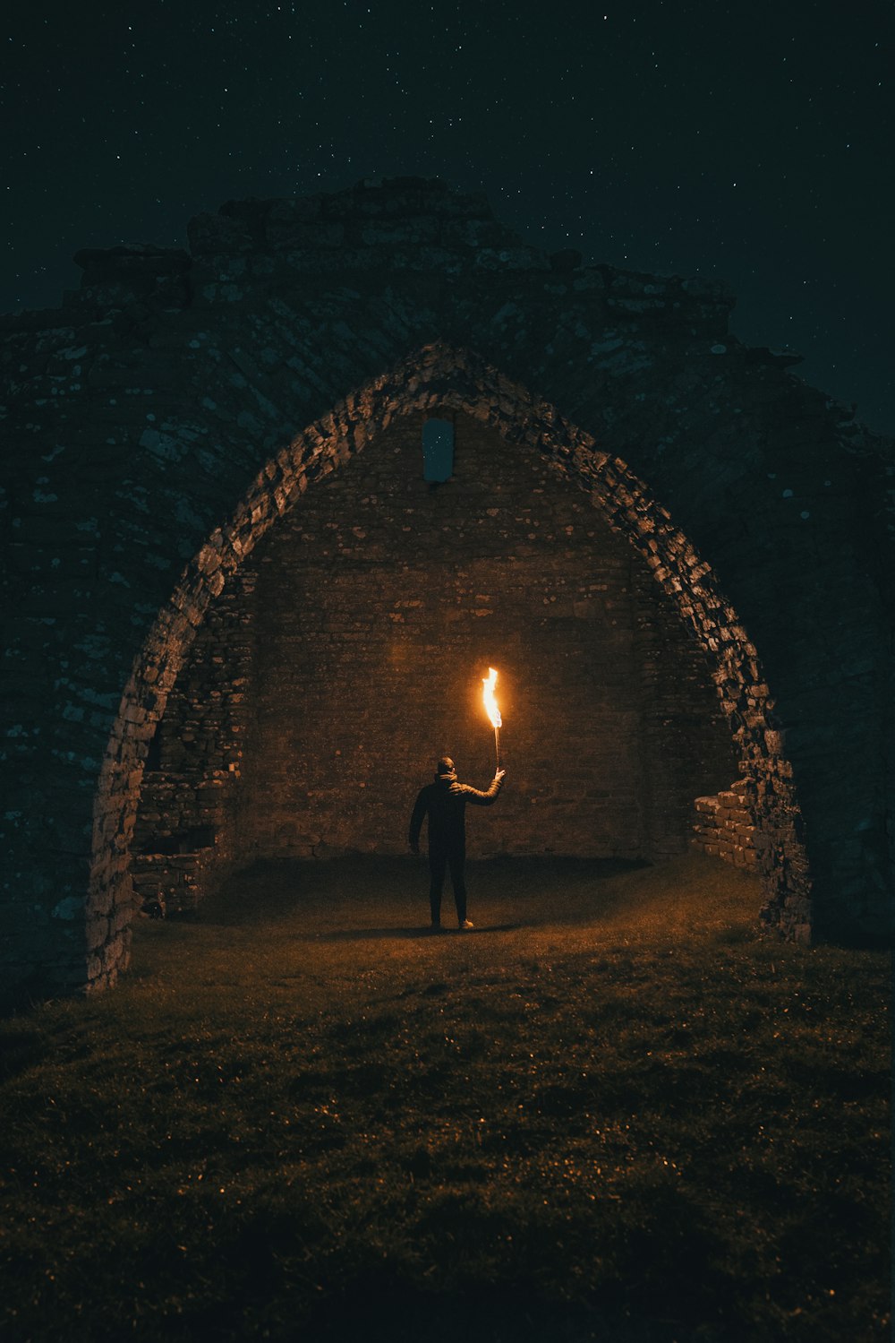 person holding torch in building interior