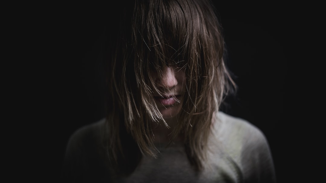 woman wearing grey shirt taking close-up selfie