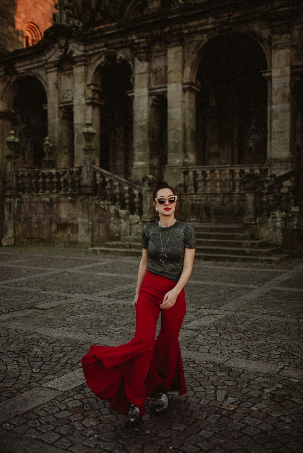 woman walking near brown concrete building