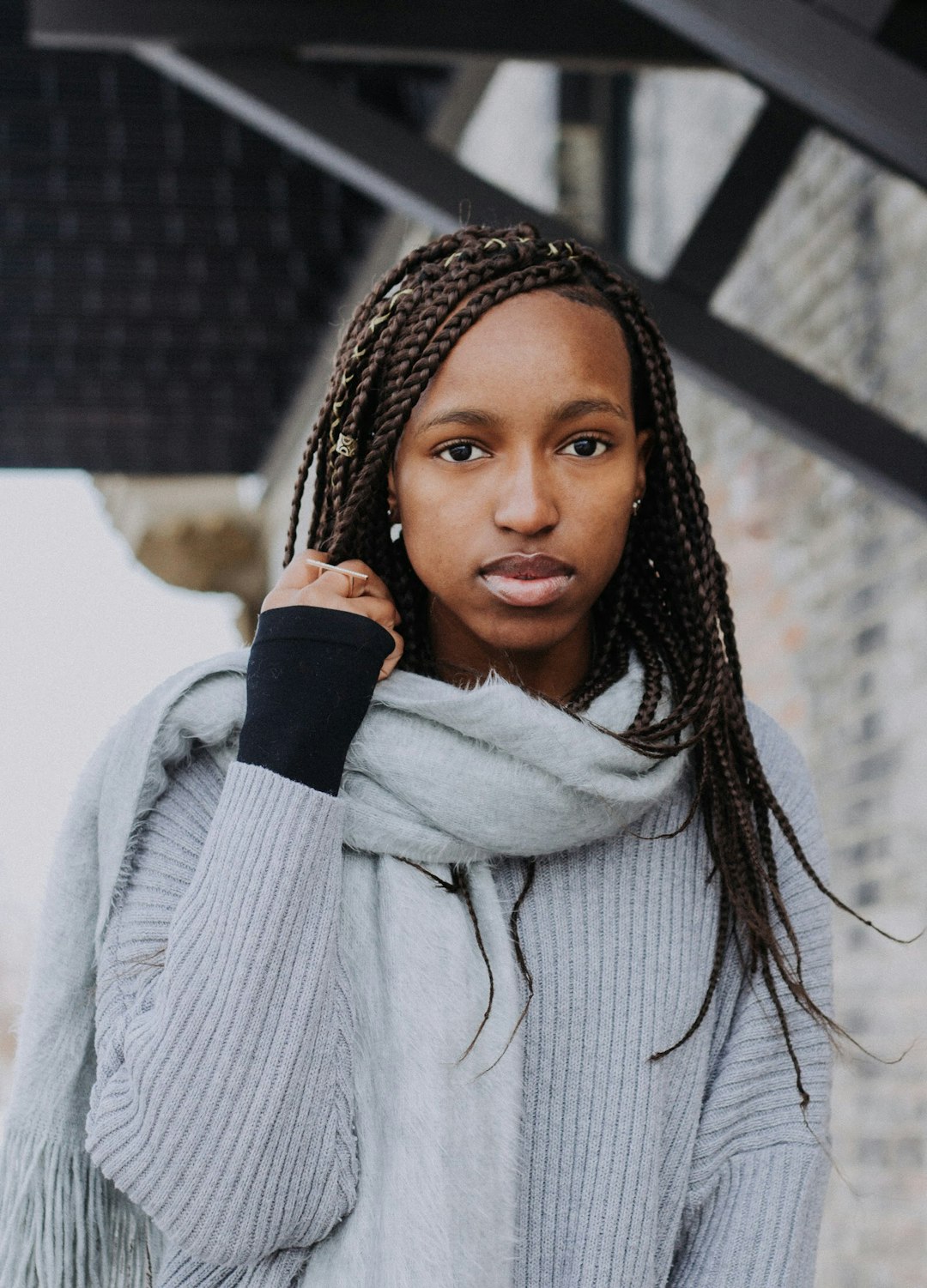 woman holding her braided hair