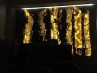 Artfully arranged onyx & oak product range on a white gallery wall with soft spotlights highlighting the textures.