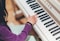 A happy student playing the piano during a lesson.
