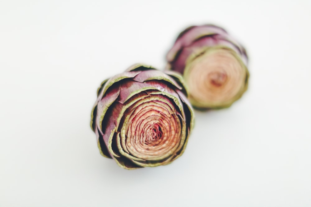 selective focus photography of red-and-green artichokes