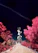 A telecommunications tower is positioned at the center of a rocky pathway, surrounded by vibrant, surreal pink foliage and a deep blue sky. A distinct contrail stretches diagonally across the sky, adding to the otherworldly atmosphere.