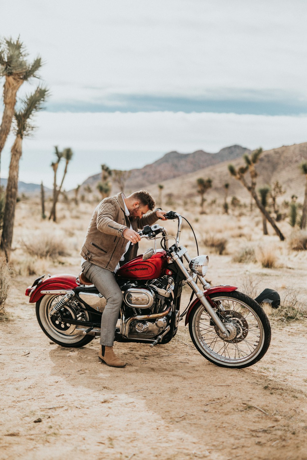 man riding red cruiser motorcycle