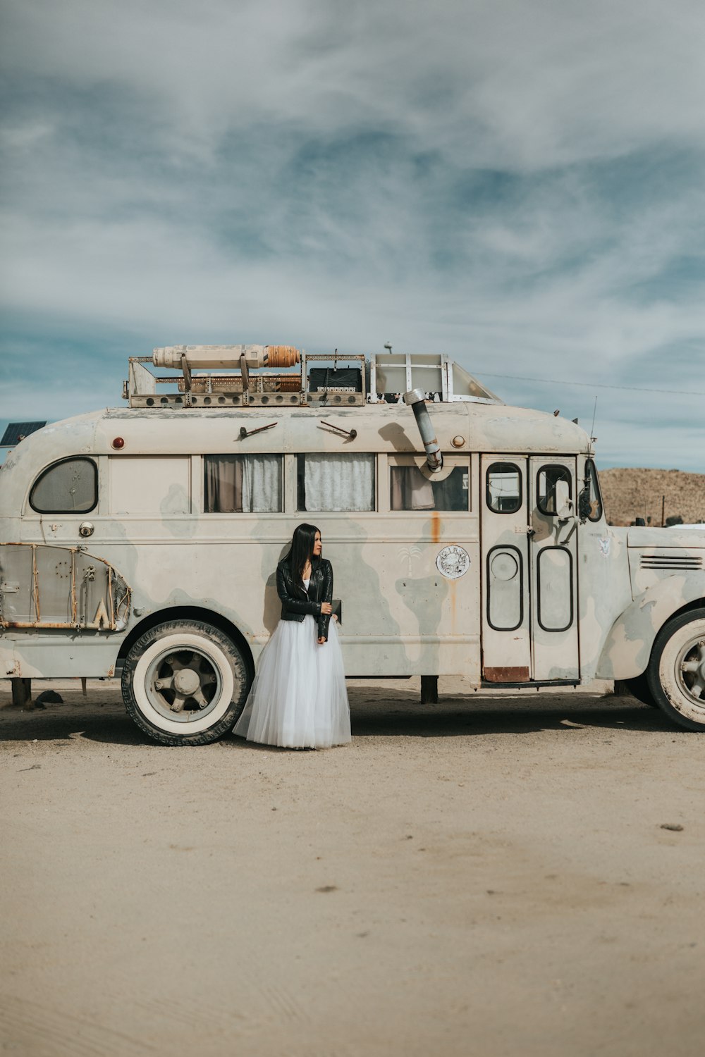 woman standing next to white RV