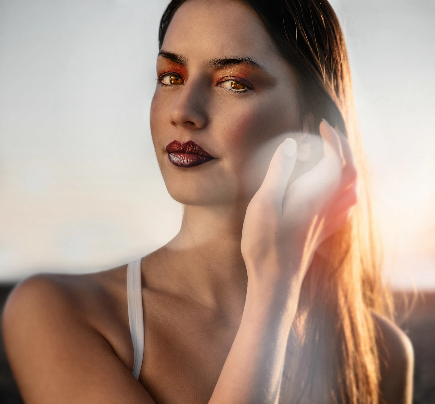 Woman's face in natural daylight with a warm glow, representing the radiance a Brightening Facial aims to leave skin with