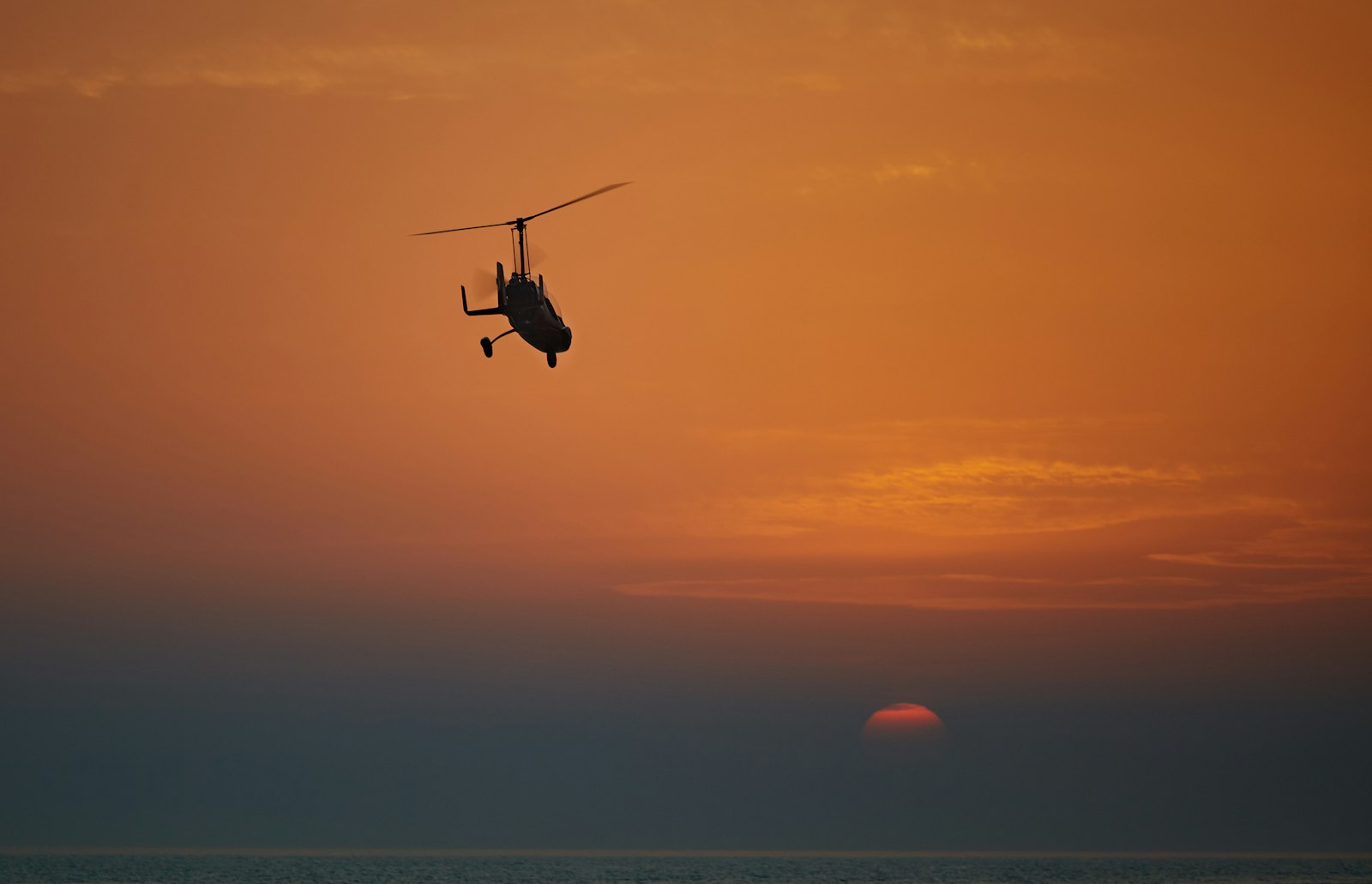 Canon EOS 5D Mark II + Canon EF 70-200mm F4L IS USM sample photo. Silhouette of helicopter flying photography