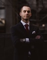 man wearing black notched lapel suit jacket in focus photography