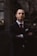man wearing black notched lapel suit jacket in focus photography