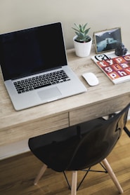 MacBook Pro on table with Magic Mouse