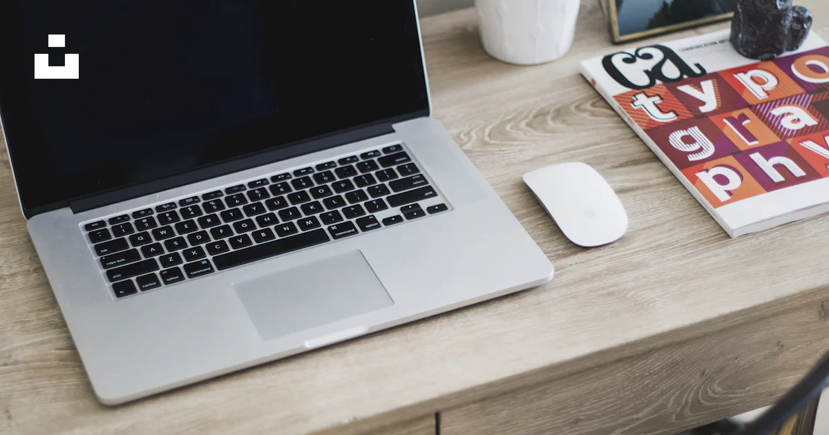 MacBook Pro on table with Magic Mouse photo – Free Office Image on Unsplash