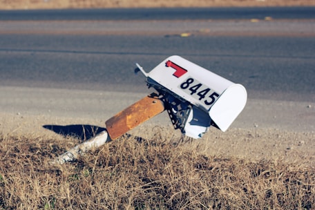 white mailbox on road at daytime