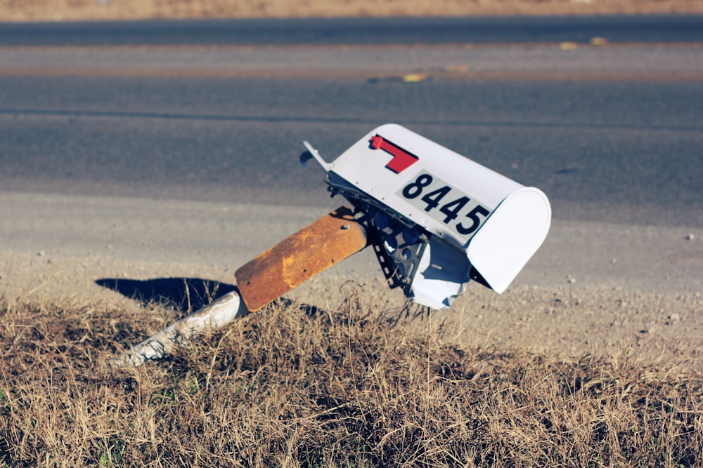 white mailbox on road at daytime