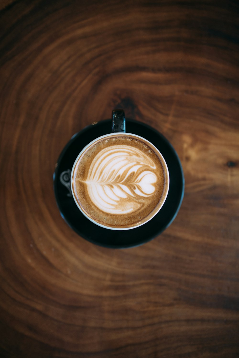 white and black ceramic mug with liquid