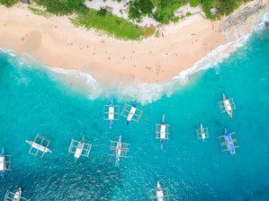 bird's-eye photography of boats on body of water near islet