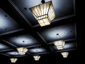 Cluster of small, geometric ceiling lights creating a striking pattern of light and shadow.