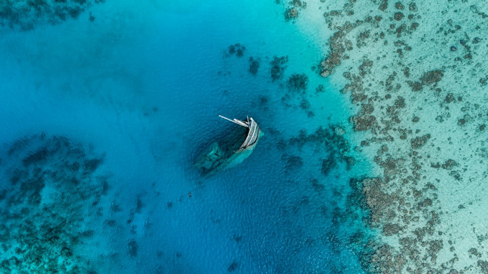 an aerial view of a boat in the water