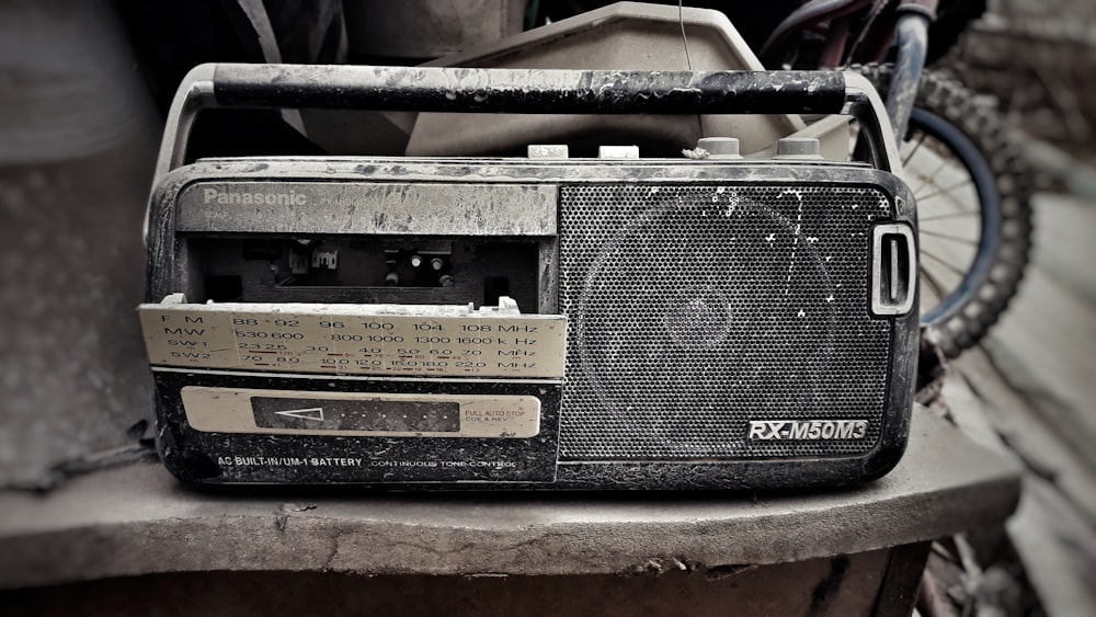 grey and black Panasonic RX-M50M3 transistor radio on grey surface