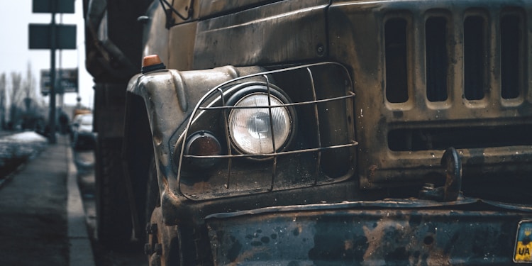 closeup photo of gray vehicle on road