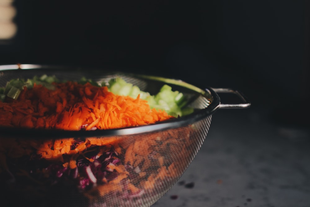 chopped vegetables on gray steel strainer