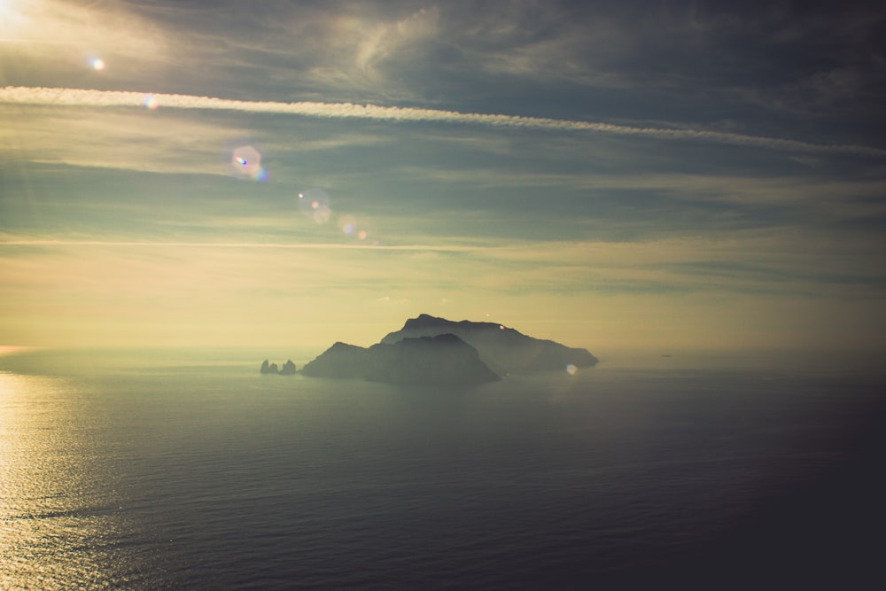 island on calm body of water