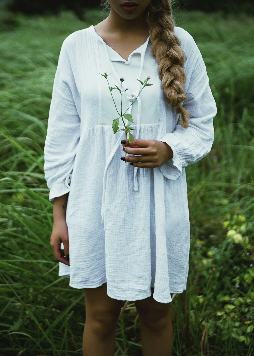 woman in white long-sleeved dress on gras