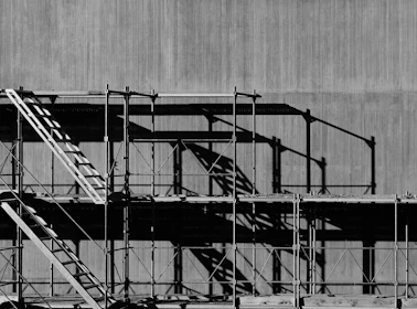 grayscale photography of piled racks