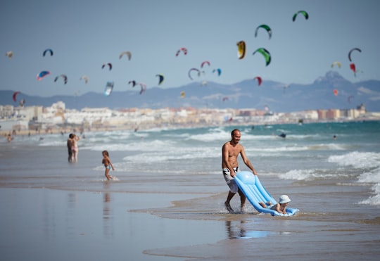 people swimming on beach during daytime in Tarifa Spain