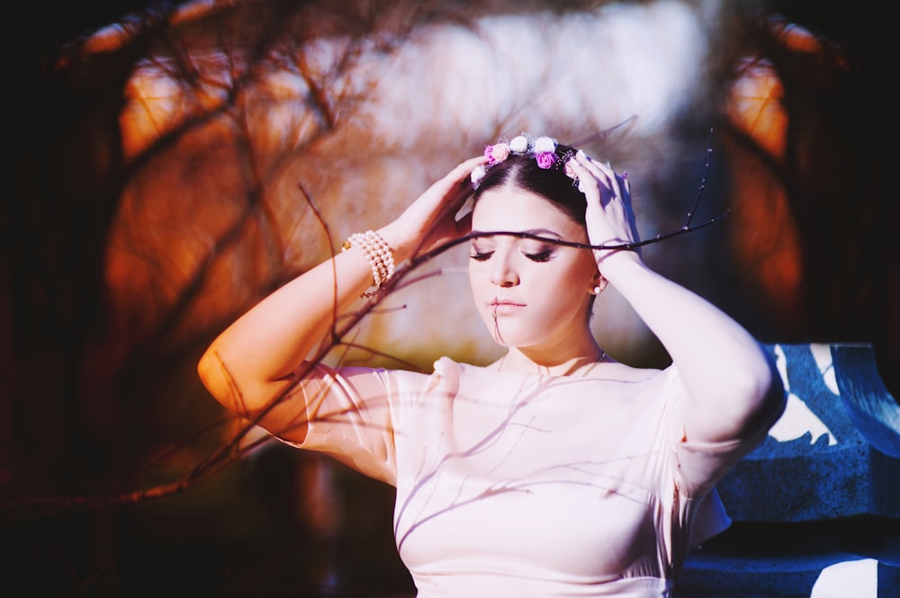 woman holding her hair during daytime