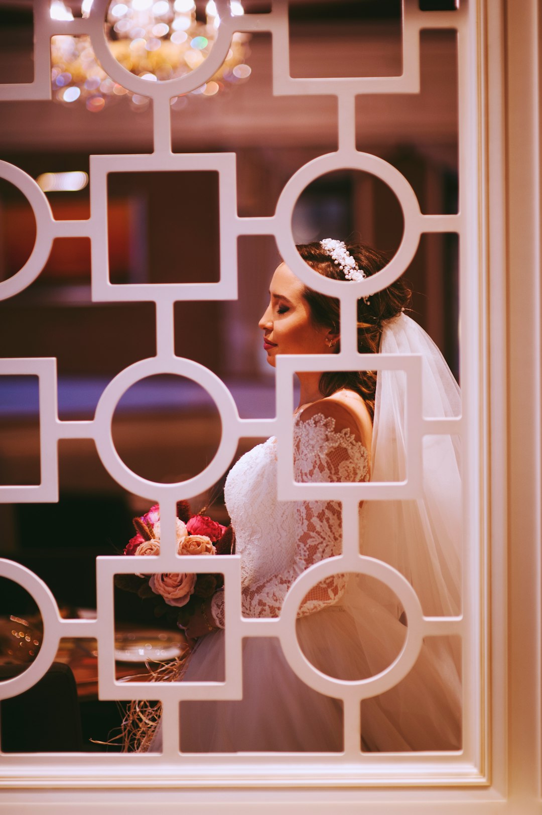 woman in white wedding gown holding flowers