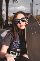 woman holding longboard during daytime