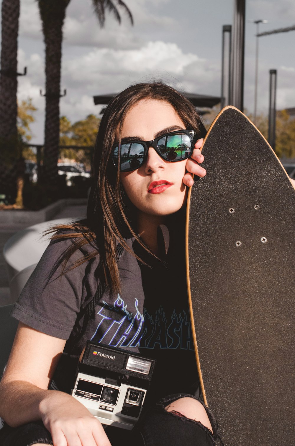 woman holding longboard during daytime