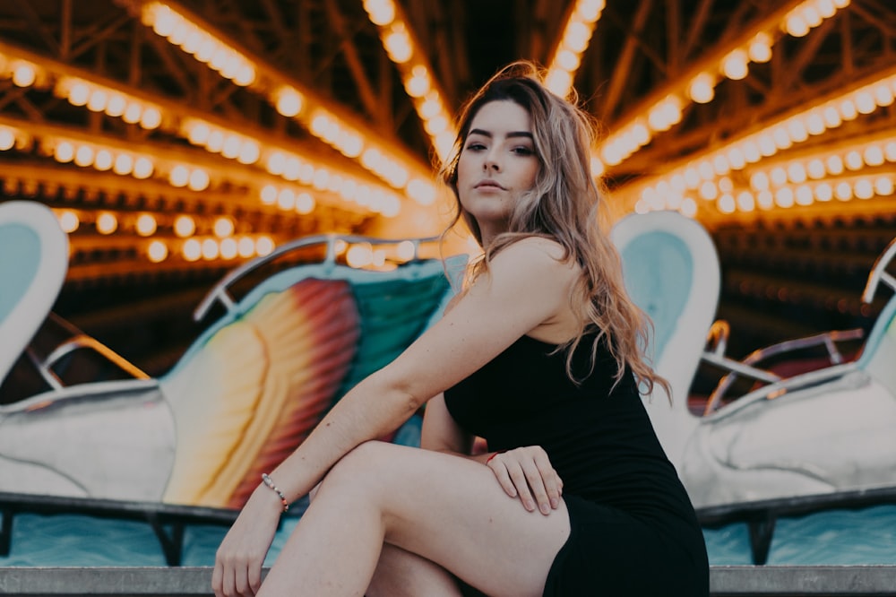woman sitting in front of amusement ride