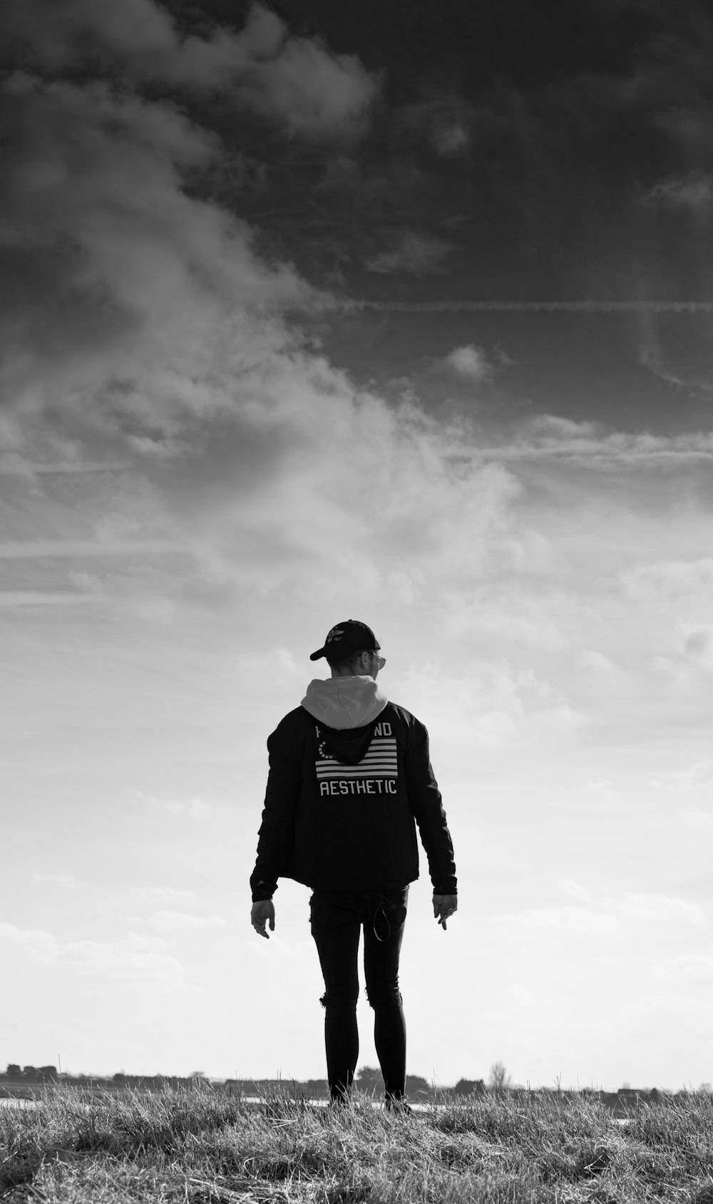 grayscale photography of man wearing hoodie