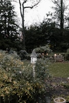 A serene garden with blooming flowers and a small birdhouse.