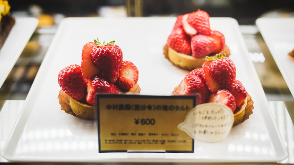 red strawberries on white ceramic tray